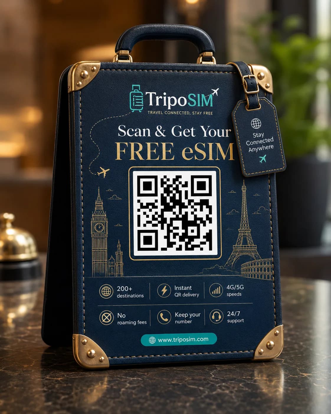 TripoSIM travel-eSIM QR standee — a premium navy suitcase display on a hotel counter reading Scan & Get Your FREE eSIM, with 200+ destinations, instant QR delivery and 4G/5G speeds
